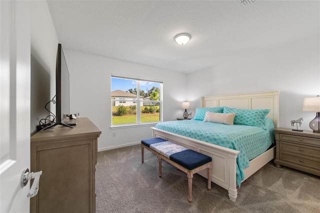 carpeted bedroom with a textured ceiling