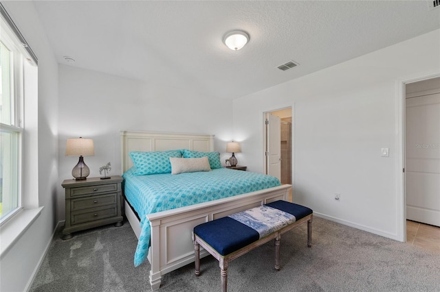 carpeted bedroom featuring a textured ceiling