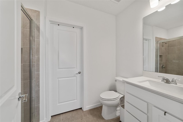 bathroom featuring vanity, toilet, walk in shower, and tile patterned floors