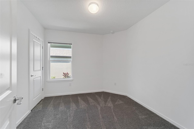 carpeted spare room featuring a textured ceiling