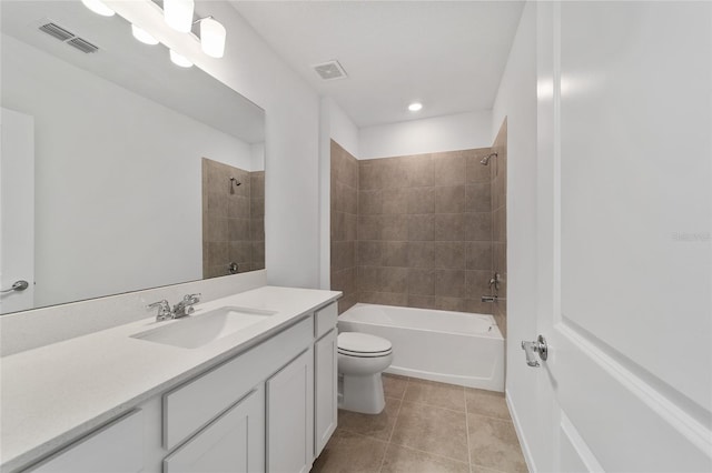 full bathroom featuring tiled shower / bath, tile patterned flooring, vanity, and toilet