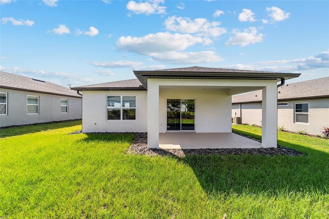 rear view of property featuring a patio area and a lawn