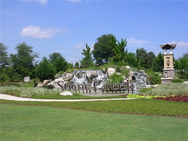 community / neighborhood sign with a lawn