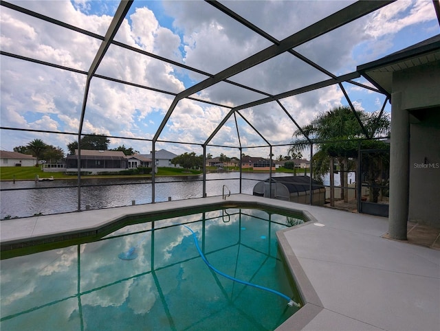 view of pool featuring a lanai, a water view, and a patio area