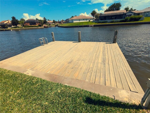 dock area featuring a water view and a yard