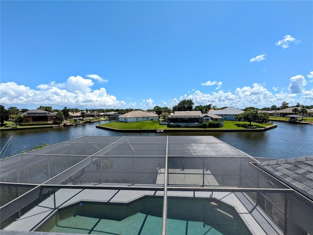 view of pool with a water view and glass enclosure