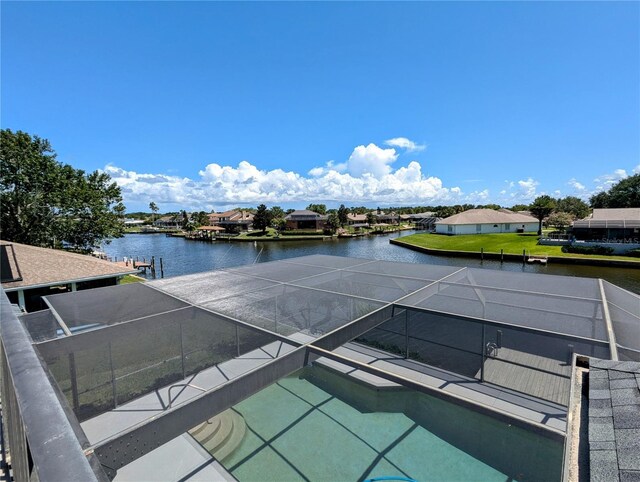 view of swimming pool featuring a water view