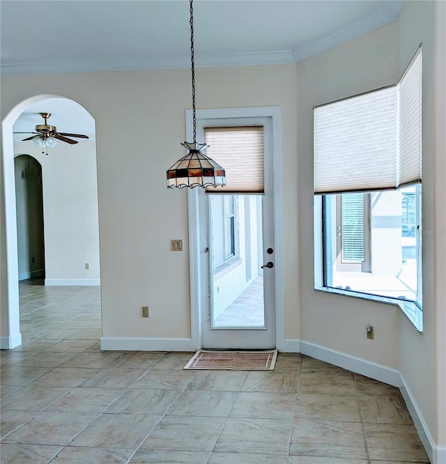 interior space featuring ceiling fan and ornamental molding