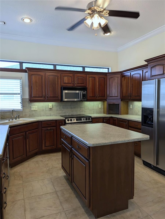 kitchen with stainless steel appliances, crown molding, tasteful backsplash, and a center island