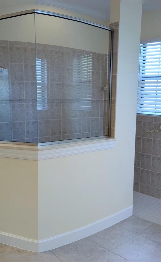 bathroom featuring tiled shower and tile patterned floors