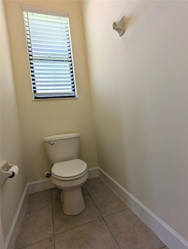 bathroom featuring tile patterned flooring and toilet