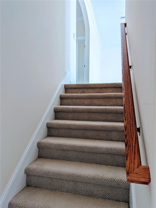 stairs with crown molding