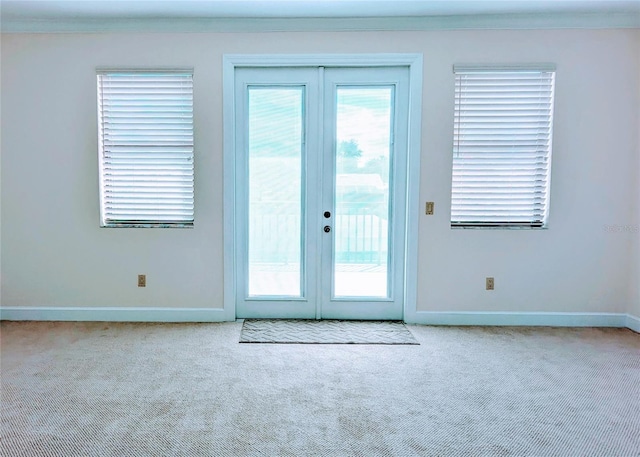 entryway with light colored carpet and french doors