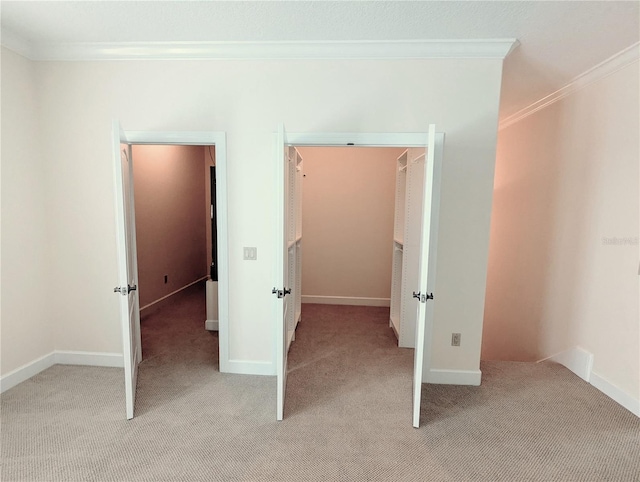 unfurnished bedroom featuring light colored carpet and crown molding