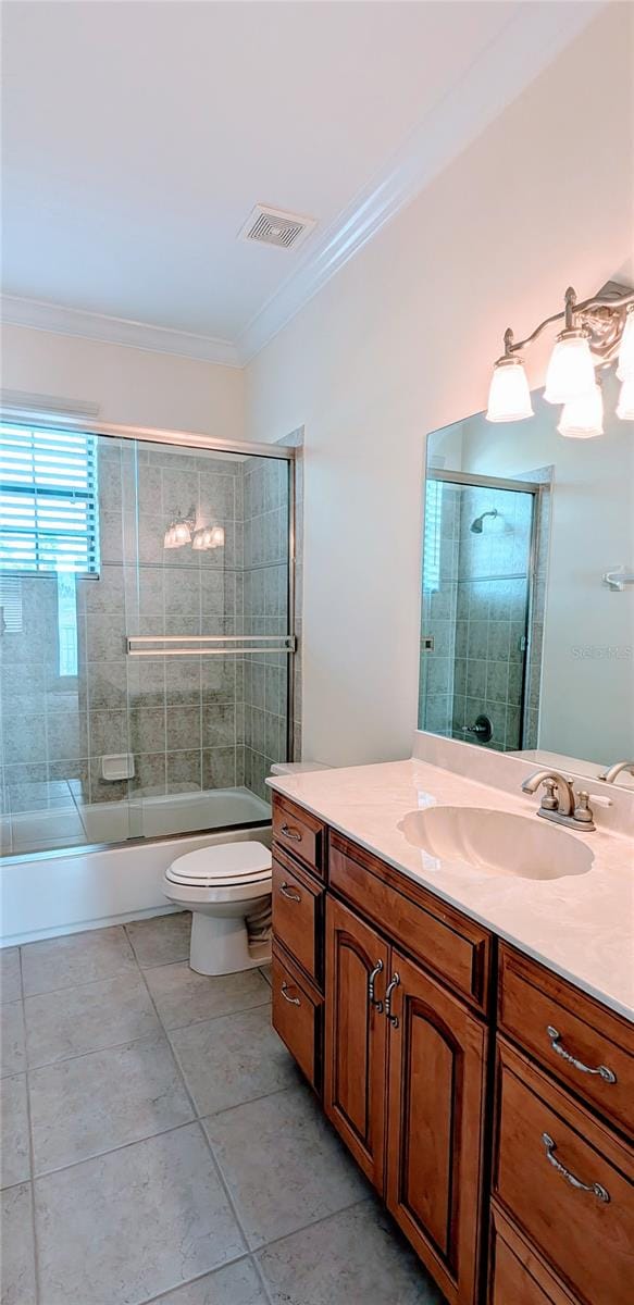 full bathroom featuring shower / bath combination with glass door, vanity, crown molding, and toilet