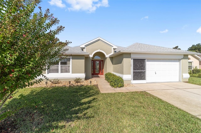 single story home featuring a front lawn and a garage