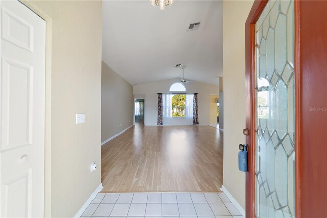 entryway with vaulted ceiling and light hardwood / wood-style flooring