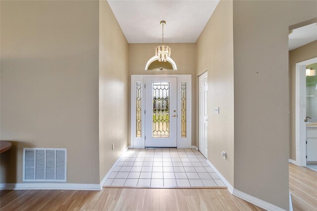 entrance foyer featuring a notable chandelier and light hardwood / wood-style floors