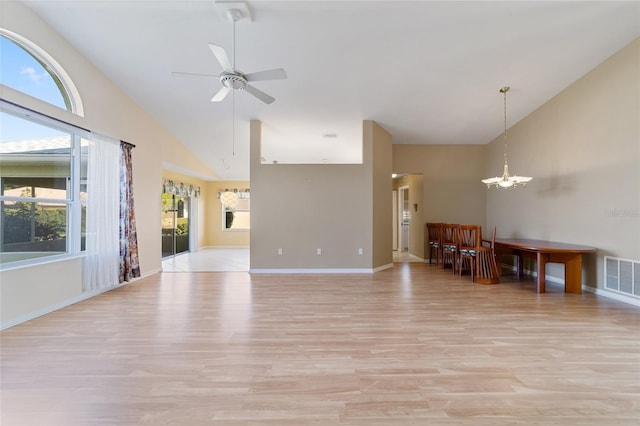 unfurnished living room with high vaulted ceiling, ceiling fan, light hardwood / wood-style flooring, and plenty of natural light