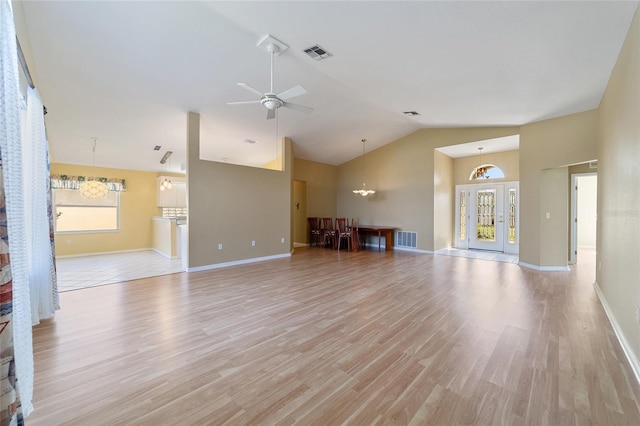 unfurnished living room with ceiling fan, lofted ceiling, light hardwood / wood-style floors, and a healthy amount of sunlight