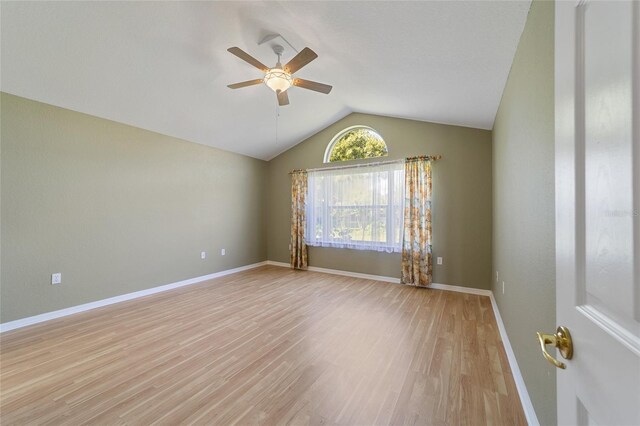 empty room featuring light hardwood / wood-style floors, lofted ceiling, and ceiling fan