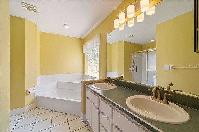 bathroom with shower with separate bathtub, vanity, and tile patterned floors