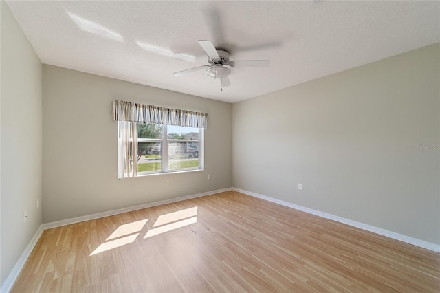 unfurnished room with ceiling fan, a textured ceiling, and light hardwood / wood-style flooring