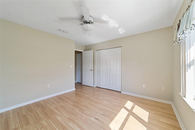 unfurnished bedroom featuring light wood-type flooring and ceiling fan