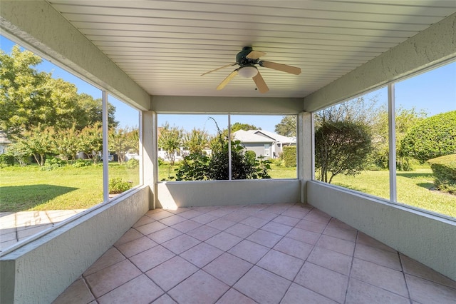 unfurnished sunroom with wood ceiling and ceiling fan