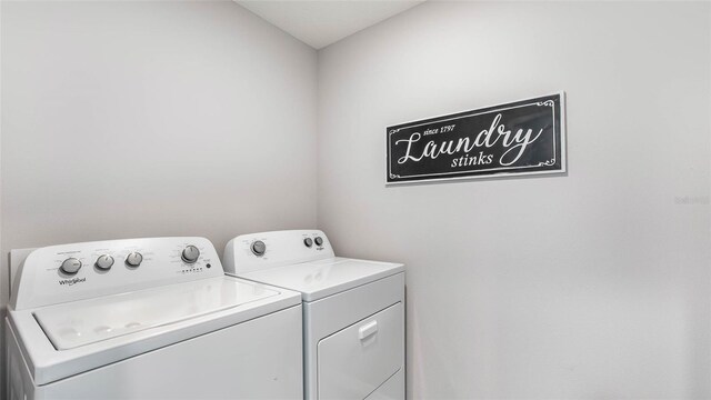 clothes washing area with independent washer and dryer