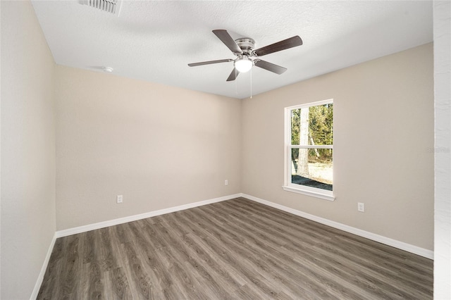 spare room with a textured ceiling, dark hardwood / wood-style flooring, and ceiling fan