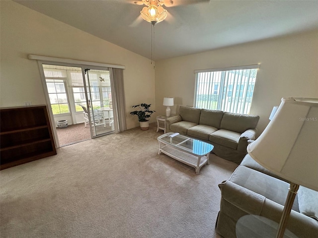 living room featuring ceiling fan, lofted ceiling, light carpet, and a healthy amount of sunlight