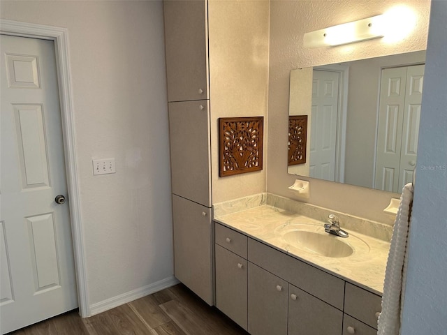 bathroom featuring vanity and hardwood / wood-style flooring