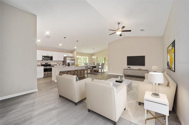 living room featuring light wood-type flooring, lofted ceiling, and ceiling fan