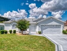 ranch-style house with a garage and a front yard