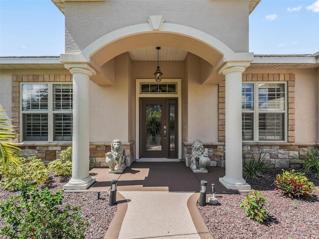 view of exterior entry with covered porch