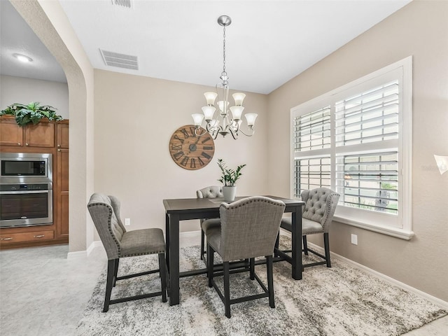 dining room with a notable chandelier