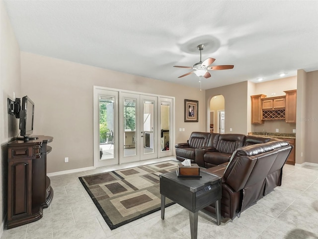 tiled living room featuring ceiling fan