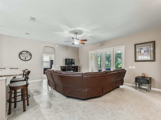 living room with light tile patterned floors and ceiling fan