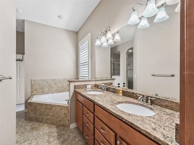 bathroom with a relaxing tiled tub and vanity