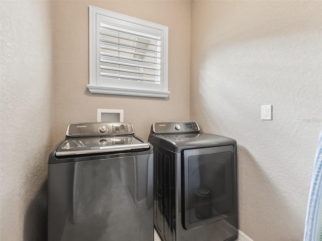 laundry area with washing machine and clothes dryer