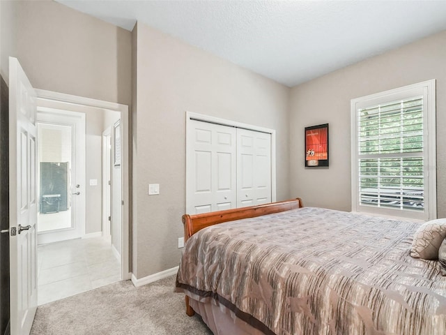 bedroom with light carpet and a closet