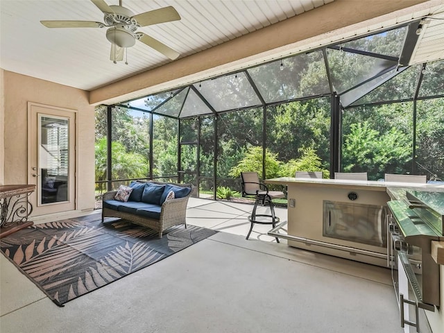 sunroom / solarium featuring ceiling fan