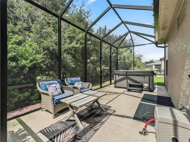 view of patio / terrace with a hot tub and glass enclosure