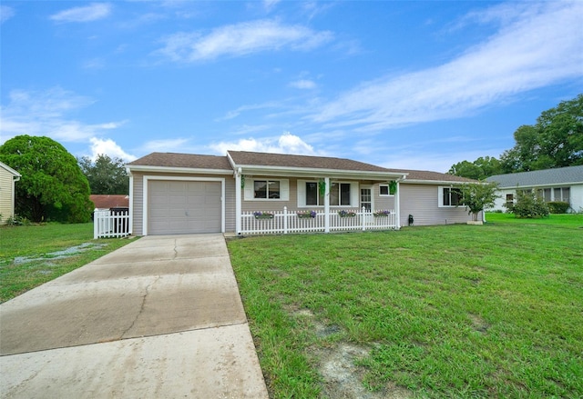 single story home featuring a porch, a garage, driveway, and a front yard