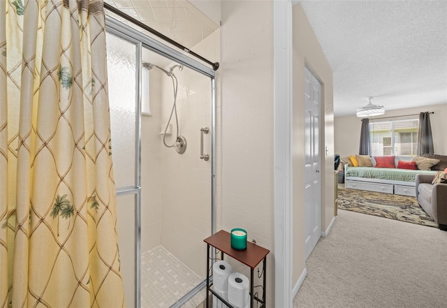 bathroom with a textured ceiling and an enclosed shower