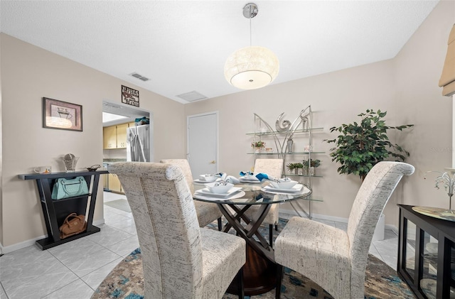 dining space with baseboards and visible vents
