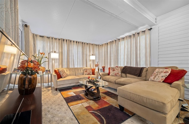 living room featuring crown molding and wood walls