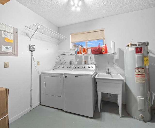 laundry room with electric water heater, washer and clothes dryer, a textured ceiling, and sink