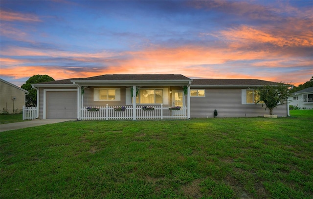 ranch-style house with fence, an attached garage, a porch, a front yard, and concrete driveway
